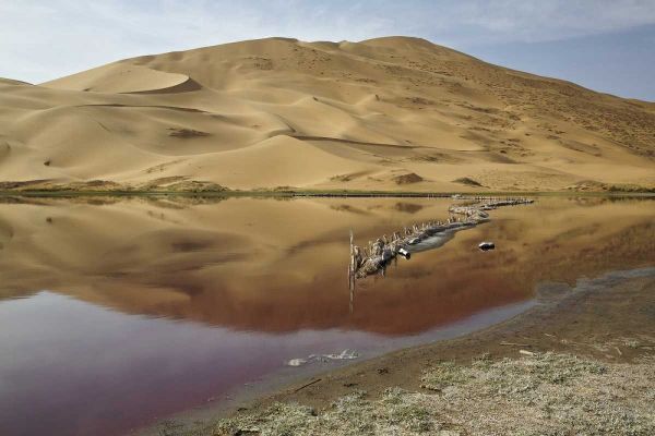 China, Badain Jaran Desert Dune reflects in lake